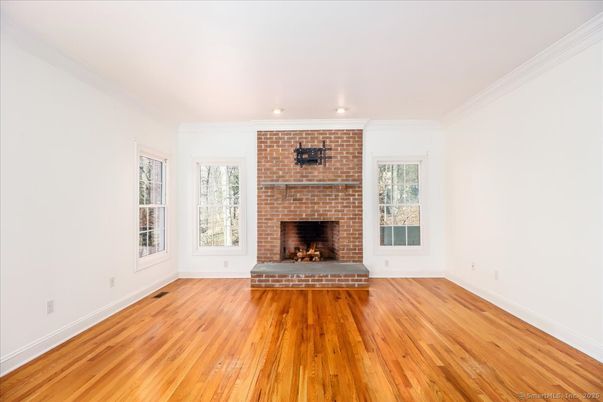 Empty room, Fireplace, Interior, Recessed Lighting, Stone Walls, Wood Texture Flooring