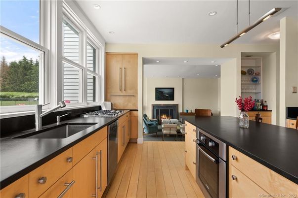 Fireplace, Interior, Kitchen, Living room, Recessed Lighting, Stainless Steel Appliances, Wood Texture Flooring