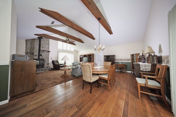 Chandelier, Dining room, Fireplace, Interior, Living room, Pendant Lights, Stone Walls, Wooden Beams, Wood Texture Flooring