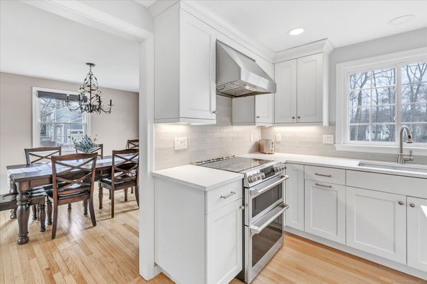 Chandelier, Dining room, Interior, Kitchen, Recessed Lighting, Stainless Steel Appliances, Wood Texture Flooring