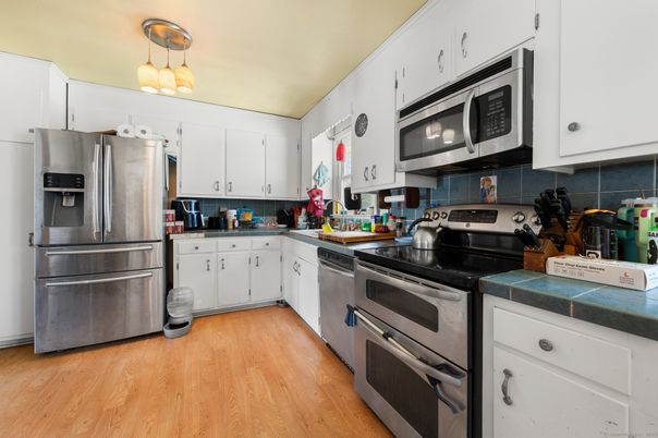 Interior, Kitchen, Stainless Steel Appliances, Tile Countertops, Wood Texture Flooring