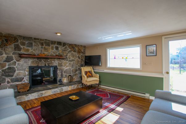 Fireplace, Interior, Living room, Recessed Lighting, Stone Walls, Wood Texture Flooring