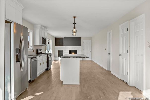 Fireplace, Interior, Kitchen, Pendant Lights, Stainless Steel Appliances, Wood Texture Flooring