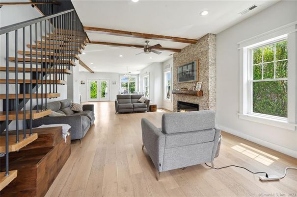 Fireplace, Interior, Living room, Recessed Lighting, Stone Walls, Wood Texture Flooring
