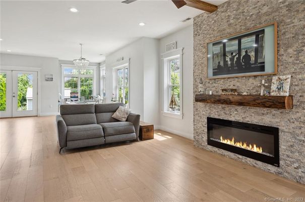 Chandelier, Dining room, Fireplace, Interior, Living room, Pendant Lights, Recessed Lighting, Stone Walls, Wooden Beams, Wood Texture Flooring