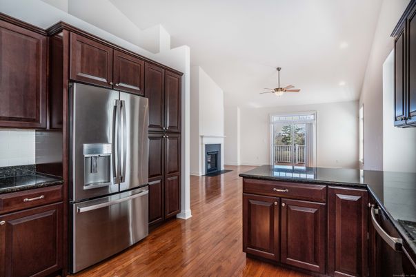 Fireplace, Interior, Kitchen, Recessed Lighting, Stainless Steel Appliances, Wood Texture Flooring