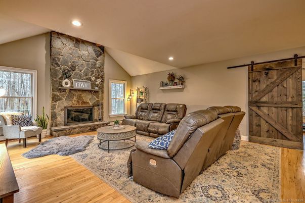 Fireplace, Interior, Living room, Recessed Lighting, Stone Walls, Wood Texture Flooring