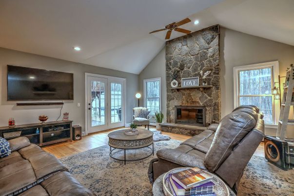 Fireplace, Interior, Living room, Recessed Lighting, Stone Walls, Wood Texture Flooring