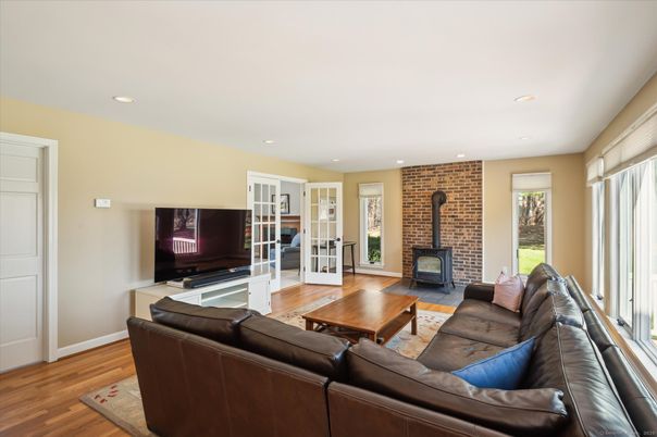 Fireplace, Interior, Living room, Recessed Lighting, Stone Walls, Wood Texture Flooring