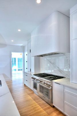 Interior, Kitchen, Marble Walls, Recessed Lighting, Stainless Steel Appliances, Wood Texture Flooring