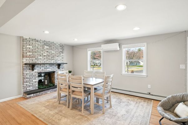 Dining room, Fireplace, Interior, Recessed Lighting, Stone Walls, Wood Texture Flooring