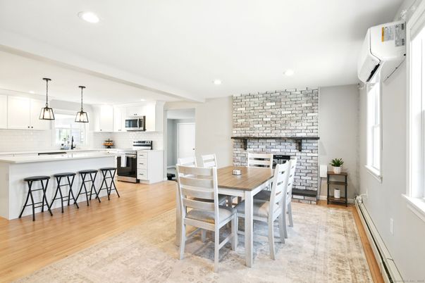 Dining room, Fireplace, Interior, Kitchen, Pendant Lights, Recessed Lighting, Stainless Steel Appliances, Stone Walls, Wood Texture Flooring
