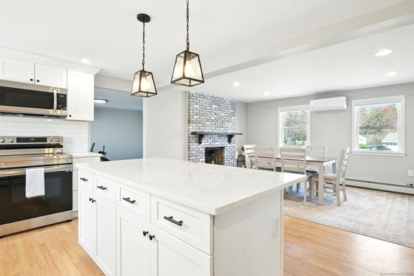 Dining room, Fireplace, Interior, Kitchen, Pendant Lights, Recessed Lighting, Stainless Steel Appliances, Stone Walls, Wood Texture Flooring