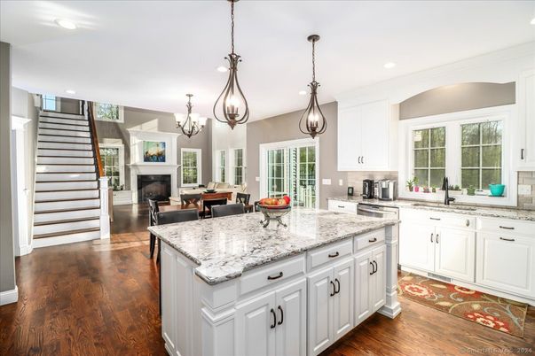 Chandelier, Dining room, Fireplace, Interior, Kitchen, Pendant Lights, Recessed Lighting, Stainless Steel Appliances, Wood Texture Flooring