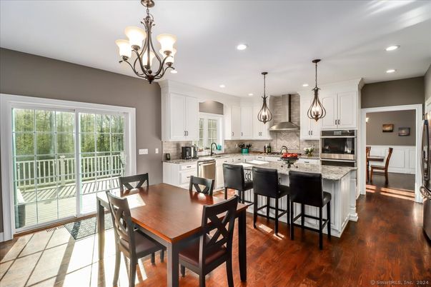 Chandelier, Dining room, Interior, Kitchen, Pendant Lights, Recessed Lighting, Stainless Steel Appliances, Wood Texture Flooring