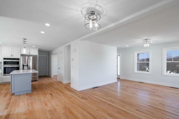 Empty room, Interior, Kitchen, Pendant Lights, Recessed Lighting, Stainless Steel Appliances, Wood Texture Flooring