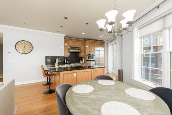 Chandelier, Dining room, Interior, Kitchen, Pendant Lights, Recessed Lighting, Stainless Steel Appliances, Wood Texture Flooring