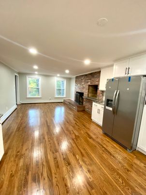 Empty room, Fireplace, Interior, Kitchen, Recessed Lighting, Stone Walls, Wood Texture Flooring