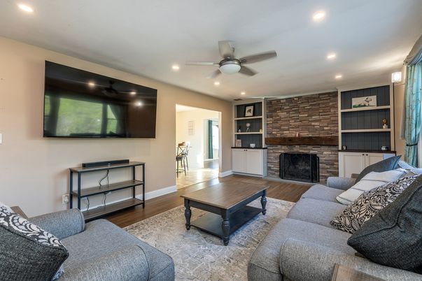 Fireplace, Interior, Living room, Recessed Lighting, Stone Walls, Wood Texture Flooring