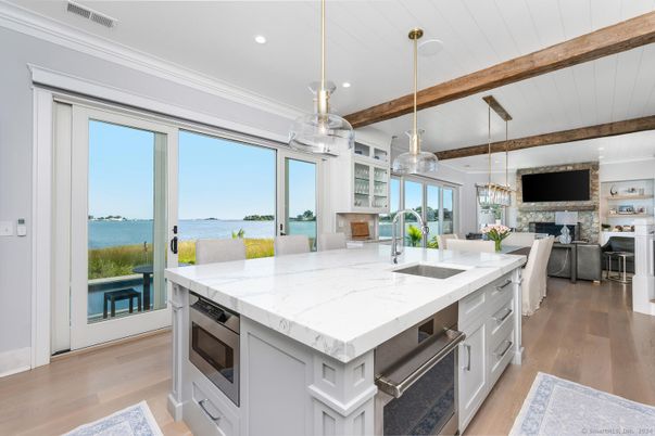 Dining room, Fireplace, Interior, Kitchen, Living room, Pendant Lights, Recessed Lighting, Stainless Steel Appliances, Water, Wooden Beams, Wood Texture Flooring