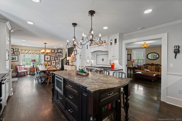 Chandelier, Dining room, Interior, Kitchen, Living room, Pendant Lights, Recessed Lighting, Stainless Steel Appliances, Wood Texture Flooring