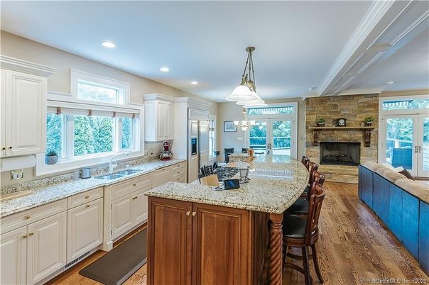 Dining room, Fireplace, Interior, Kitchen, Pendant Lights, Recessed Lighting, Stainless Steel Appliances, Stone Walls, Wood Texture Flooring