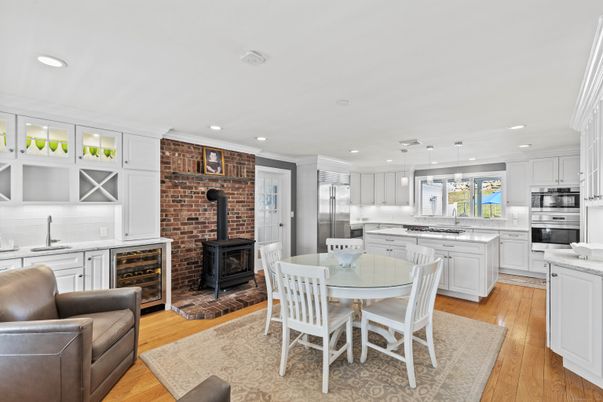 Dining room, Fireplace, Interior, Kitchen, Pendant Lights, Recessed Lighting, Stainless Steel Appliances, Stone Walls, Wood Texture Flooring