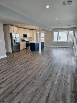 Empty room, Interior, Kitchen, Pendant Lights, Recessed Lighting, Stainless Steel Appliances, Wood Texture Flooring