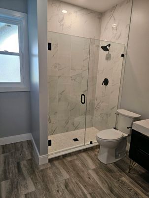 Bathroom, Glass Shower, Interior, Marble Walls, Recessed Lighting, Wood Texture Flooring