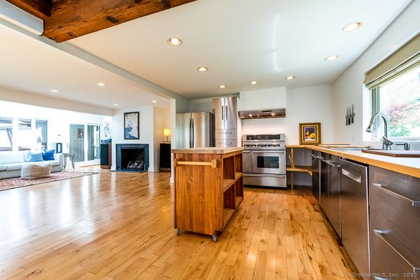Fireplace, Interior, Kitchen, Living room, Recessed Lighting, Stainless Steel Appliances, Wood Texture Flooring