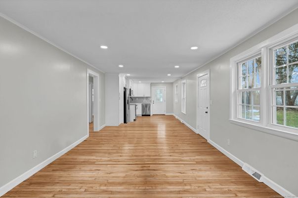 Empty room, Interior, Kitchen, Recessed Lighting, Stainless Steel Appliances, Wood Texture Flooring