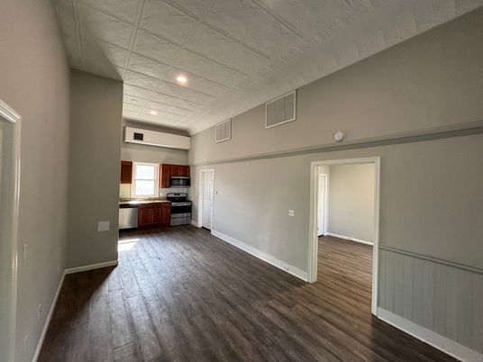 Empty room, Interior, Kitchen, Recessed Lighting, Stainless Steel Appliances, Wood Texture Flooring