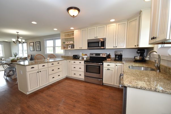 Chandelier, Dining room, Interior, Kitchen, Recessed Lighting, Stainless Steel Appliances, Wood Texture Flooring
