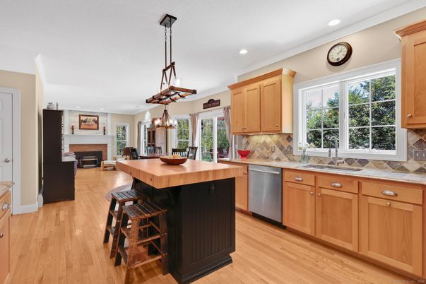 Chandelier, Dining room, Fireplace, Interior, Kitchen, Pendant Lights, Recessed Lighting, Stainless Steel Appliances, Wood Texture Flooring