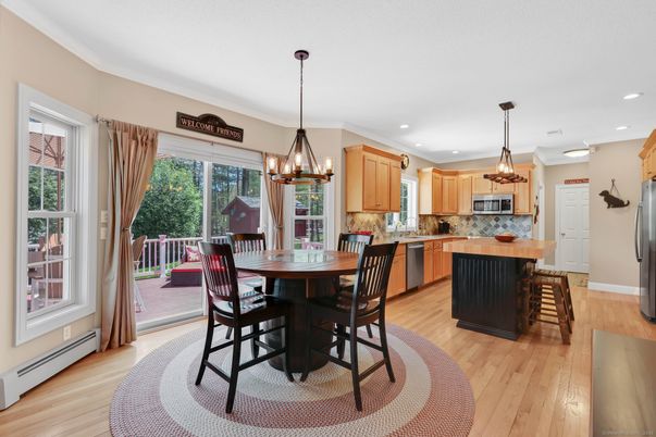Chandelier, Dining room, Interior, Kitchen, Pendant Lights, Recessed Lighting, Stainless Steel Appliances, Wood Texture Flooring
