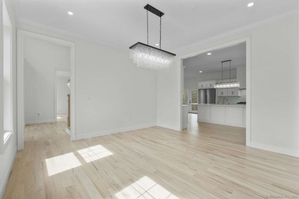 Chandelier, Empty room, Interior, Kitchen, Pendant Lights, Recessed Lighting, Stainless Steel Appliances, Wood Texture Flooring