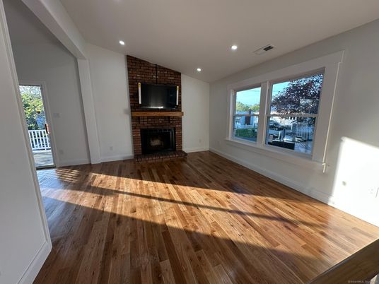 Empty room, Fireplace, Interior, Recessed Lighting, Stone Walls, Wood Texture Flooring