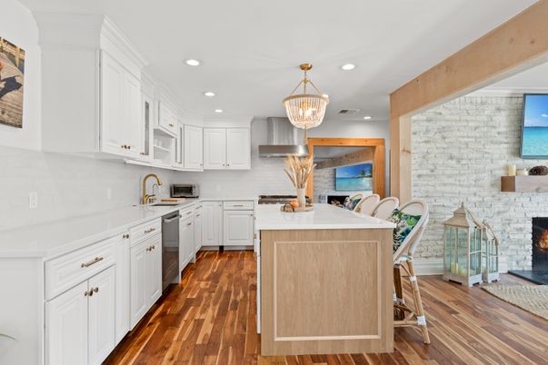 Chandelier, Fireplace, Interior, Kitchen, Pendant Lights, Recessed Lighting, Stainless Steel Appliances, Stone Walls, Wood Texture Flooring
