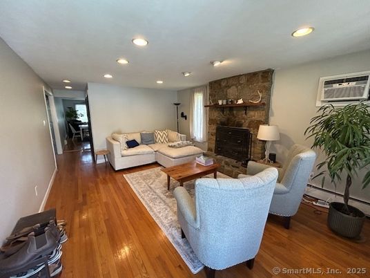 Fireplace, Interior, Living room, Recessed Lighting, Stone Walls, Wood Texture Flooring
