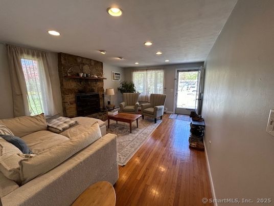 Fireplace, Interior, Living room, Recessed Lighting, Stone Walls, Wood Texture Flooring