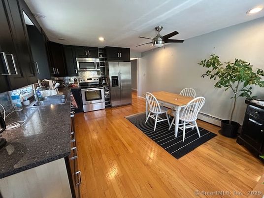 Dining room, Interior, Kitchen, Recessed Lighting, Stainless Steel Appliances, Wood Texture Flooring