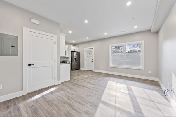 Empty room, Interior, Kitchen, Recessed Lighting, Stainless Steel Appliances, Wood Texture Flooring