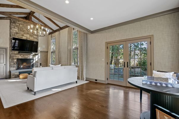 Chandelier, Fireplace, Interior, Living room, Recessed Lighting, Stone Walls, Wood Texture Flooring
