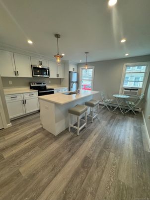 Dining room, Interior, Kitchen, Pendant Lights, Recessed Lighting, Stainless Steel Appliances, Wood Texture Flooring
