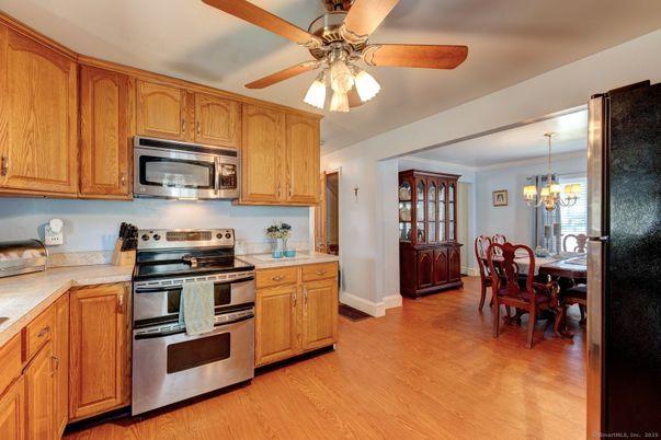 Chandelier, Dining room, Interior, Kitchen, Stainless Steel Appliances, Wood Texture Flooring