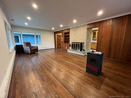 Empty room, Fireplace, Interior, Recessed Lighting, Stone Walls, Wood Texture Flooring