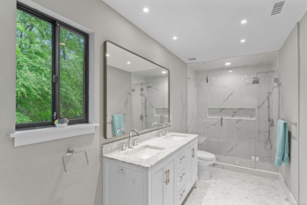 Bathroom, Dual Sink Vanities, Glass Shower, Interior, Marble, Marble Walls, Recessed Lighting