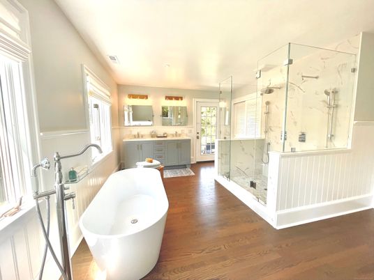 Bathroom, Dual Sink Vanities, Free Standing Baths, Glass Shower, Interior, Marble Walls, Wood Texture Flooring
