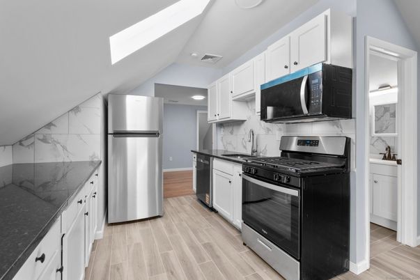 Interior, Kitchen, Marble Walls, Recessed Lighting, Stainless Steel Appliances, Wood Texture Flooring