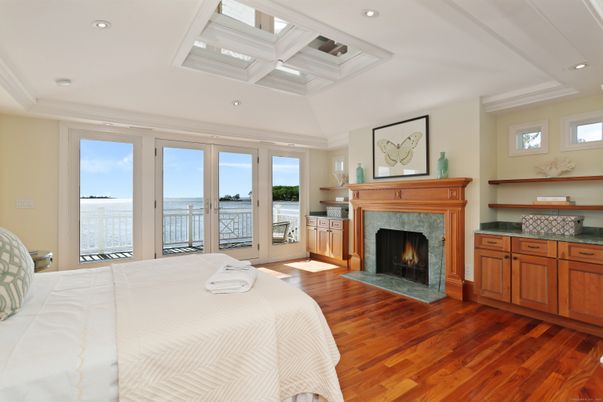 Bedroom, Fireplace, Interior, Recessed Lighting, Water, Wood Texture Flooring